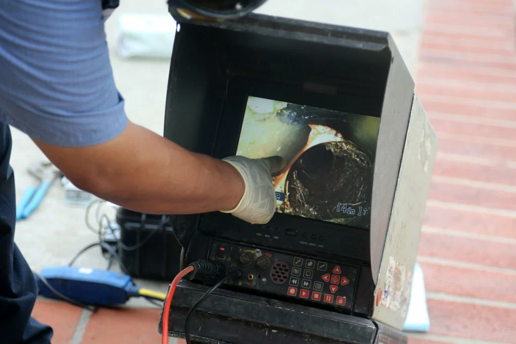 Technician viewing a drain inspection camera in Erie